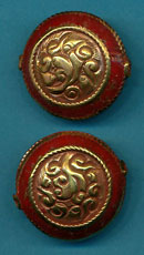 Carved brass round with coral.JPG